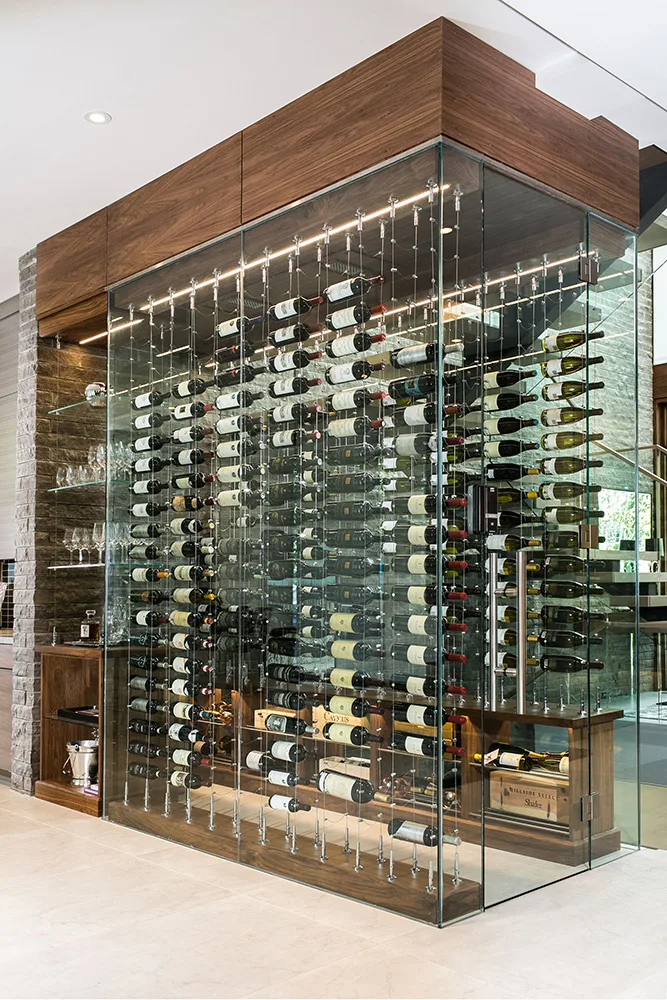 Glass-enclosed custom wine cellar installation with floor-to-ceiling wine racks