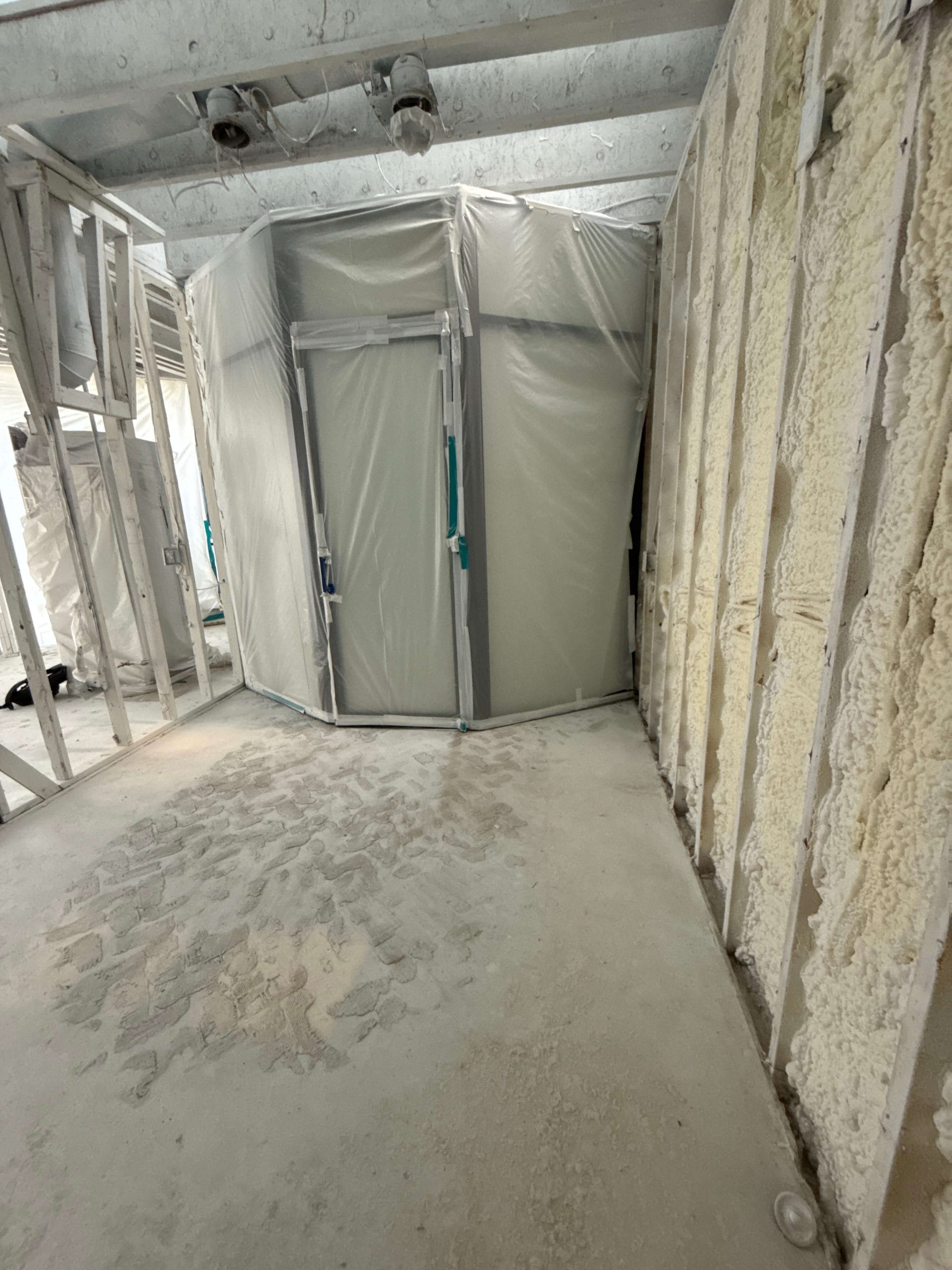 Spray foam insulation and vapor barrier installation in custom wine cellar build