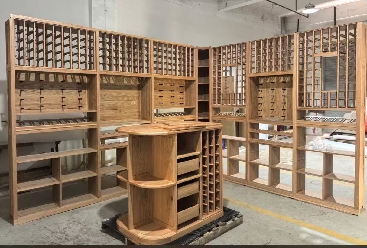 Custom wine cellar under construction with unfinished wood racking and storage displays.