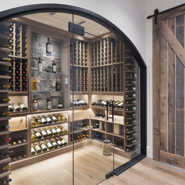 Residential wine room with modern racking, wood finishes, and climate-controlled storage.