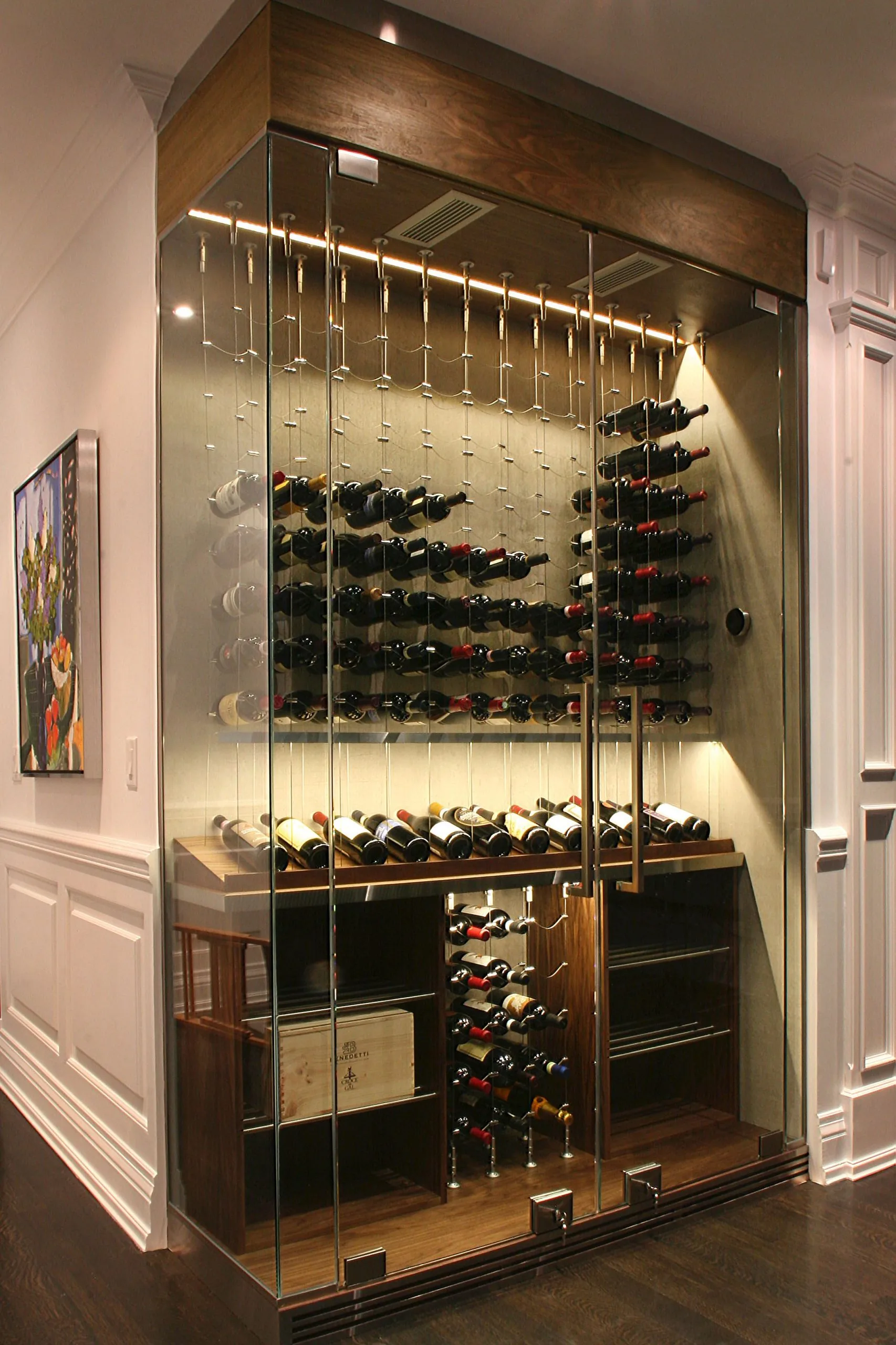 Glass wine closet with custom racking and climate-controlled bottle storage.