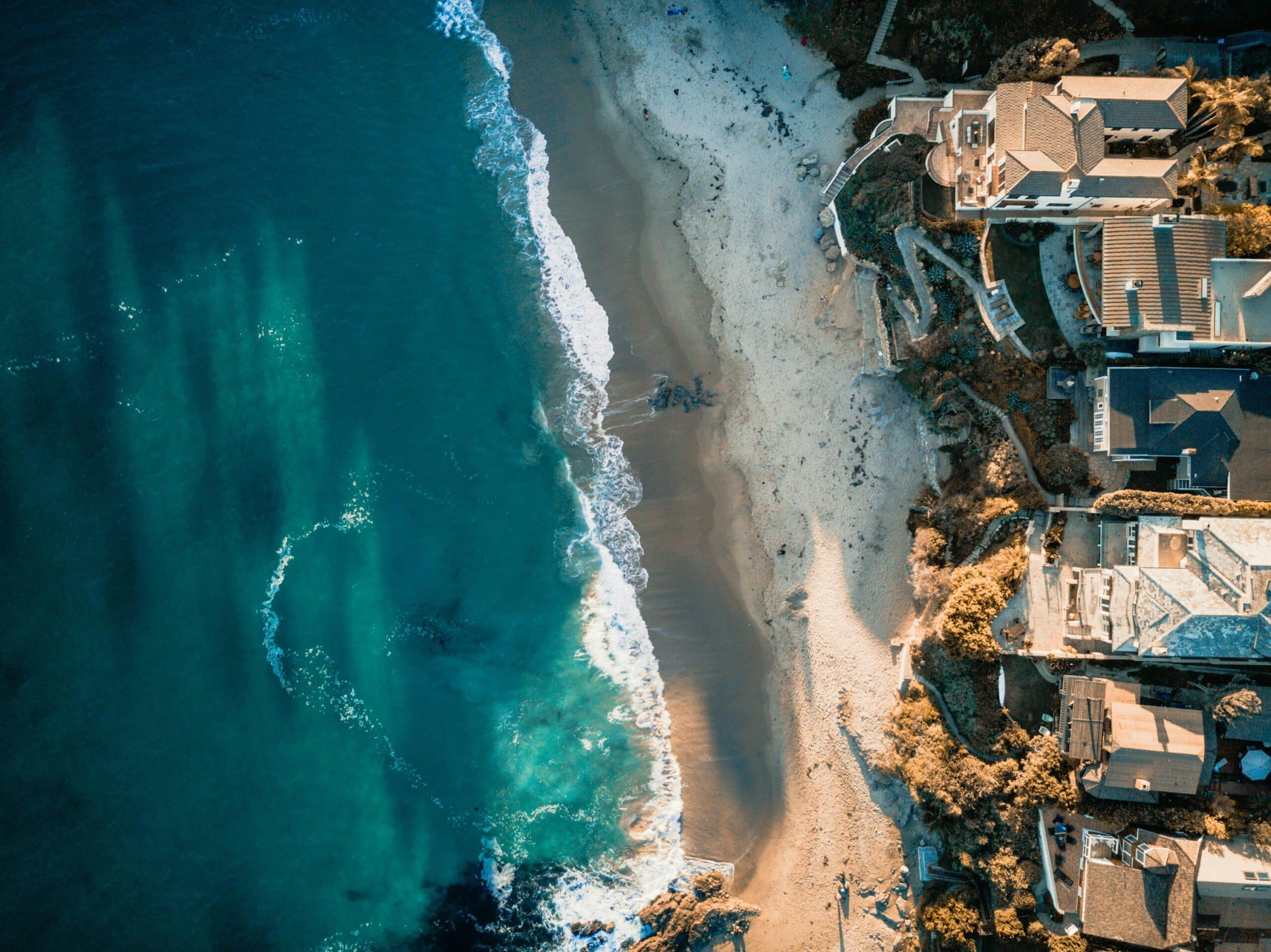 Aerial view of Laguna Beach California coastline with coastal homes, rocky shoreline and Pacific Ocean
